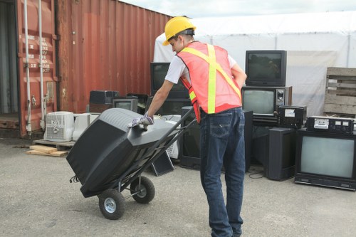 Person filling a skip with construction waste